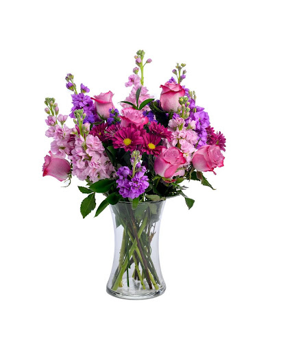 The Lush Lila is created with lavender roses, purple daisies, lavender and purple stock, purple statice, and lush foliage.
