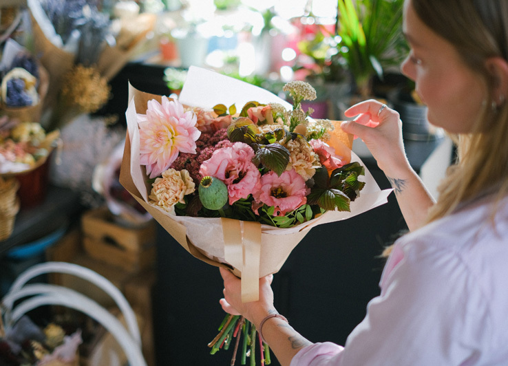 A Woman Holding a Bouquet of Flowers