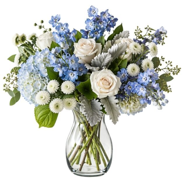 Elegant blue and white flower arrangement with roses, hydrangeas, mums, and leafy accents in a glass vase.